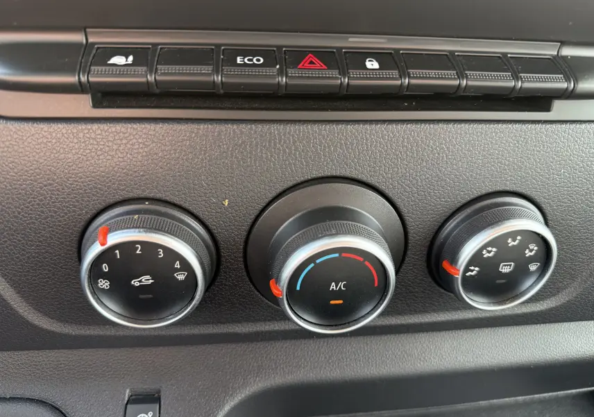 Commandes de climatisation et boutons de fonction du tableau de bord du Renault Master blanc 2020, vue en gros plan.