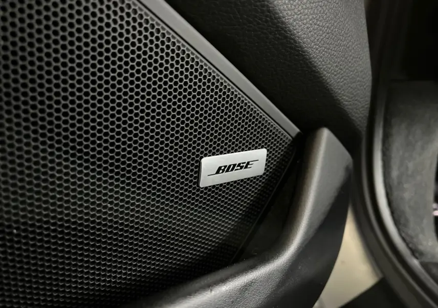 Gros plan sur l'enceinte Bose intégrée à la porte intérieure d'une Porsche 911 Carrera S argent GT.