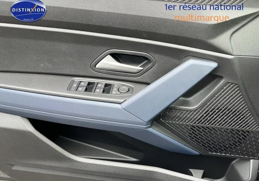 Détail de la porte avant gauche du Dacia Duster gris schiste, avec commandes des vitres et haut-parleur intégré.
