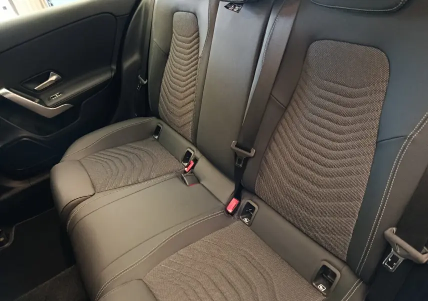 Vue intérieure de la banquette arrière noire avec surpiqûres et ceintures de sécurité de la Mercedes Classe A 250 e Hybrid.