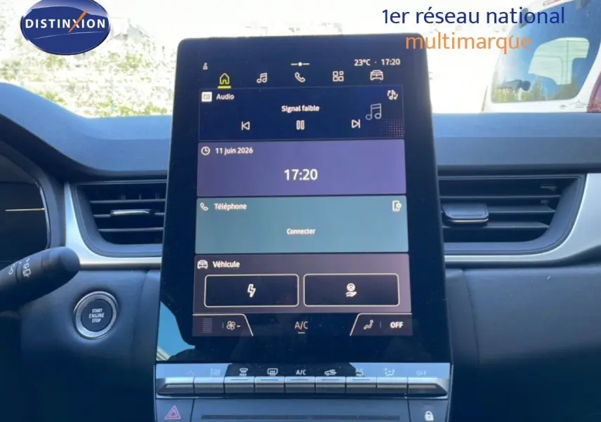 Vue intérieure centrée sur l'écran tactile du tableau de bord du Renault Captur noir étoile métal, avec bouton start visible à gauche.
