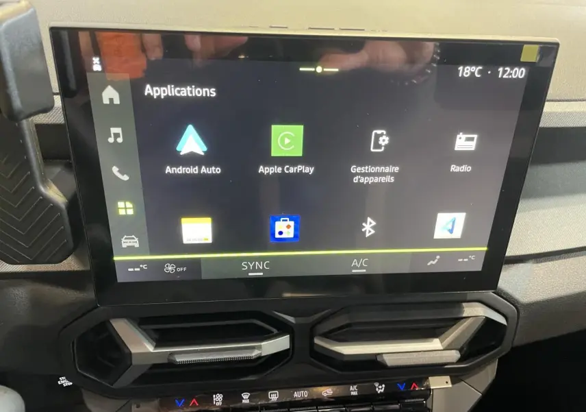 Écran tactile central du tableau de bord gris de la Dacia Bigster 1.8 Hybrid 2026 affichant les applications connectées.