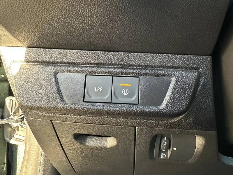 Gros plan sur les commandes LPG et verrouillage central dans l'habitacle noir du Dacia Jogger 2025.