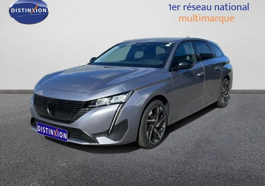 Peugeot 308 SW Hybrid gris Artense métal vue 3/4 avant droit, avec calandre noire et jantes alliage bicolores.