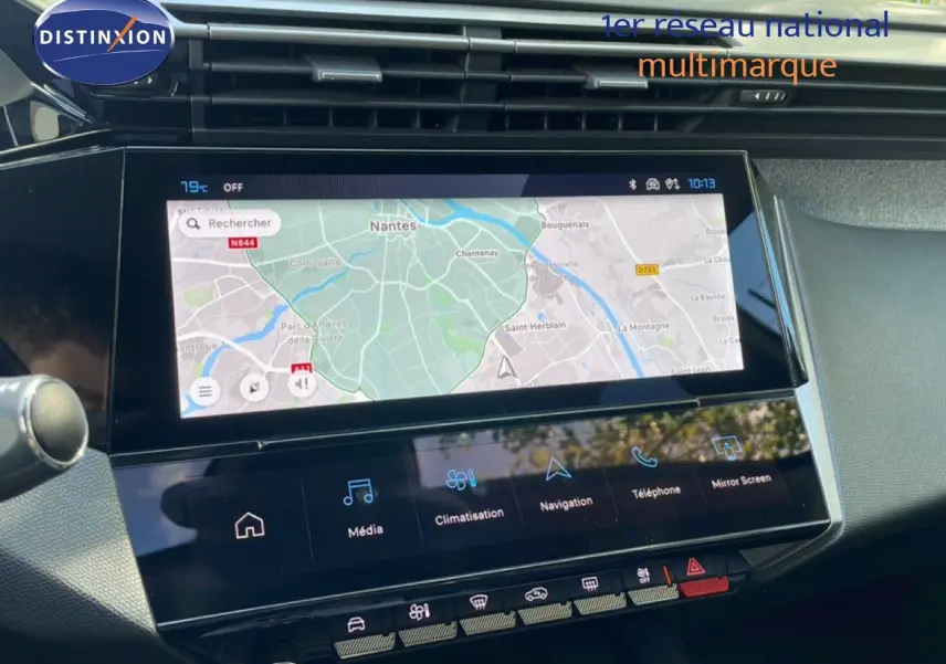 Écran tactile central de la Peugeot 308 SW Hybrid 2025 affichant la navigation avec carte de Nantes, intérieur gris noir.