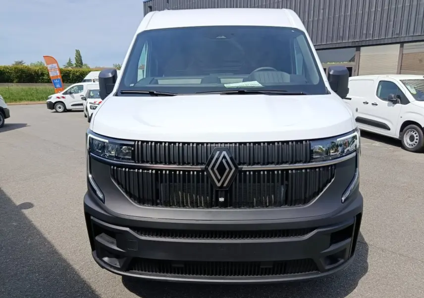 Vue frontale d’un Renault Master blanc avec calandre noire et grand logo Renault central.