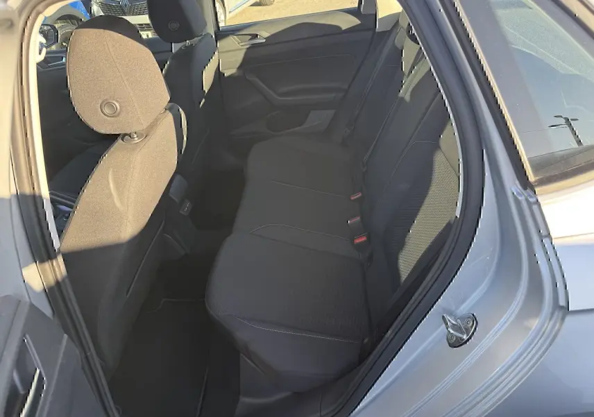Vue intérieure côté arrière droit de la Volkswagen Polo gris métal 2021, montrant les sièges arrière et la porte ouverte.