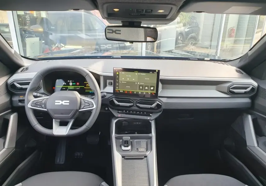 Vue intérieure avant du tableau de bord et volant du Dacia Bigster 2026 avec écran tactile et finitions noires.