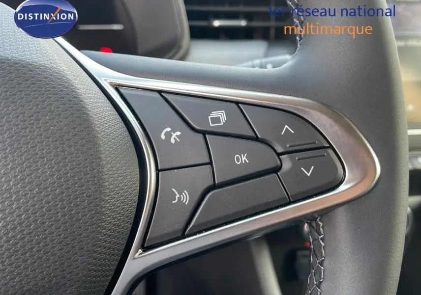 Gros plan sur les commandes multifonctions noires du volant cuir synthétique de la Renault Clio Evolution Blue dCi 100 2025.