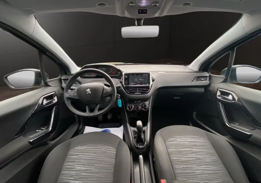 Intérieur noir de la Peugeot 208 AFFAIRE 2019, vue frontale du tableau de bord avec volant et écran GPS central.