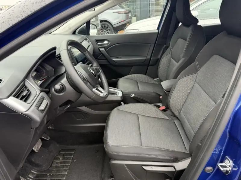 Intérieur côté conducteur du Renault Captur E-Tech 145 Zen 2022 bleu métal, sièges tissu gris et console centrale avec boîte auto.
