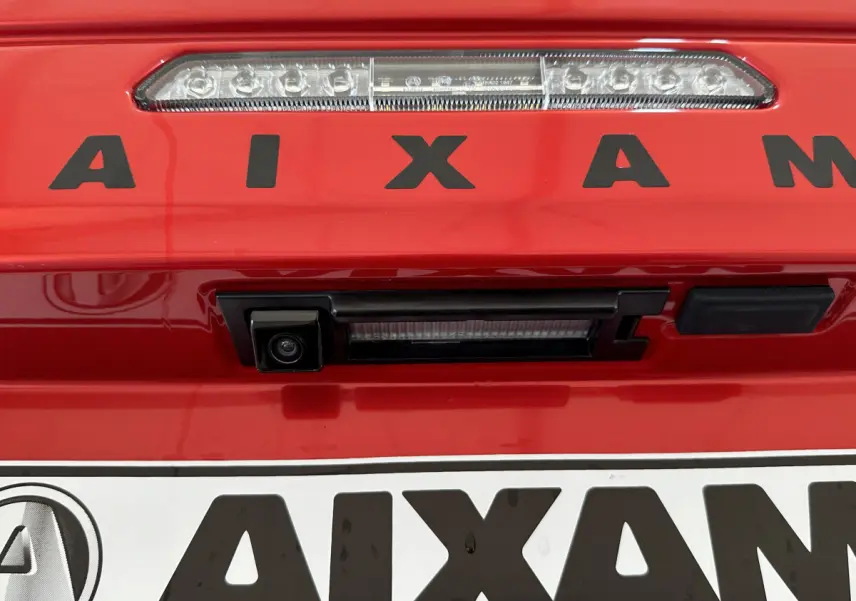 Gros plan sur la caméra de recul intégrée à la plaque arrière rouge de l'AIXAM Ambition E City Pack 2025.