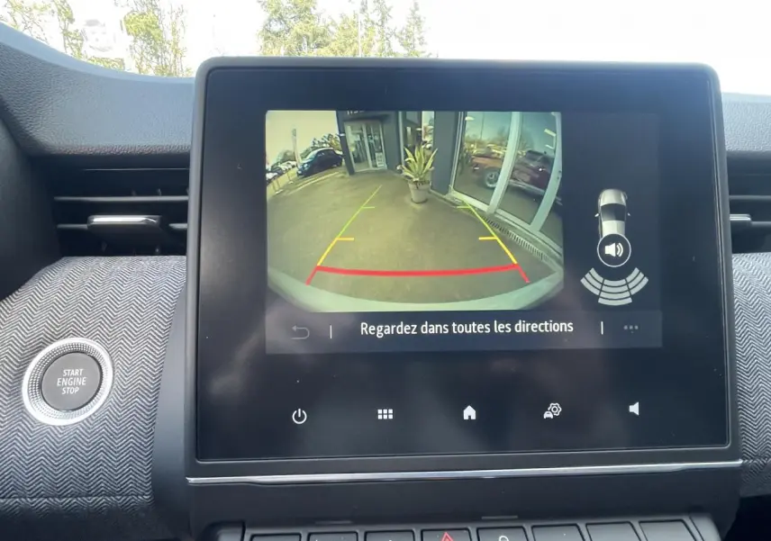 Écran multimédia affichant la caméra de recul de la Renault Clio Gris Rafale avec guidage de stationnement visible.