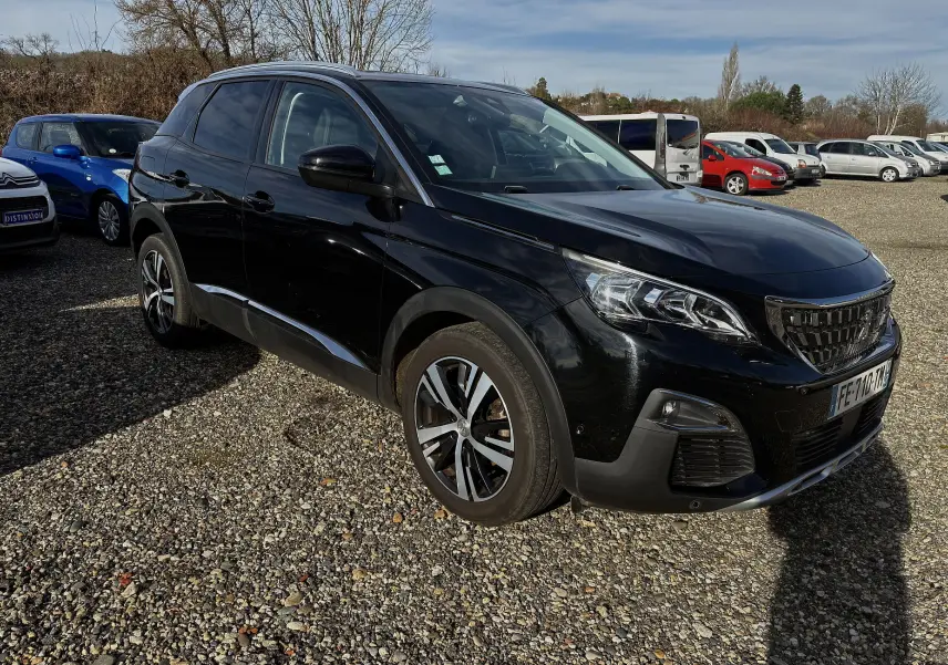 Peugeot 3008 II diesel noire vue en 3/4 avant droit sur un parking, avec jantes alliage et calandre distinctive.