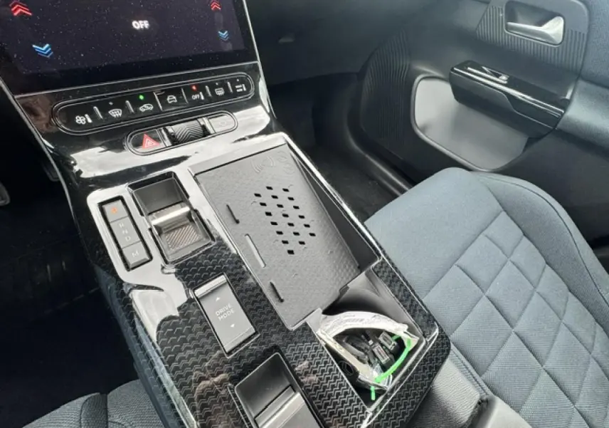 Vue intérieure centrée sur la console centrale noire brillante et siège tissu bleu du Citroën C5 Aircross 2026.
