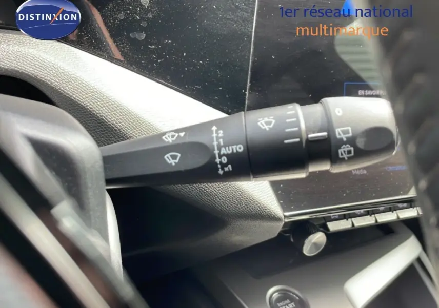 Gros plan sur la commande d’essuie-glace côté gauche du tableau de bord d’une Peugeot 308 SW noire 2025.