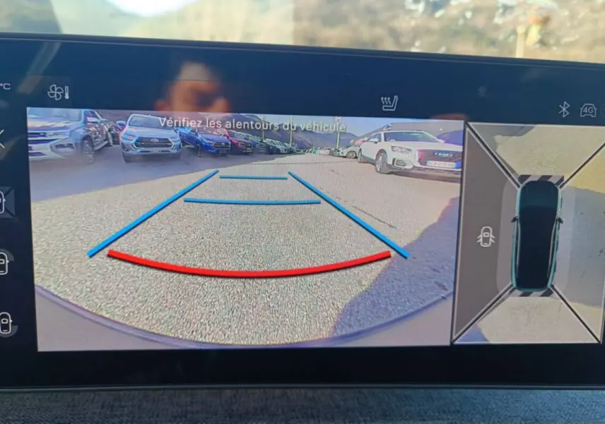 Affichage caméra de recul et vue 360° du Peugeot 3008 Hybrid 2025 avec repères de stationnement et environnement extérieur.