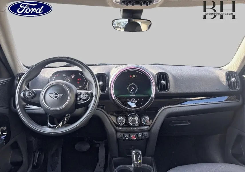 Vue intérieure frontale du tableau de bord noir du MINI Countryman Cooper D 2020 avec volant multifonction et écran circulaire central.