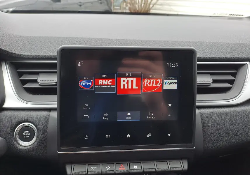 Vue rapprochée de l’écran tactile central du tableau de bord d’un Renault Captur 2022, affichant les stations radio.