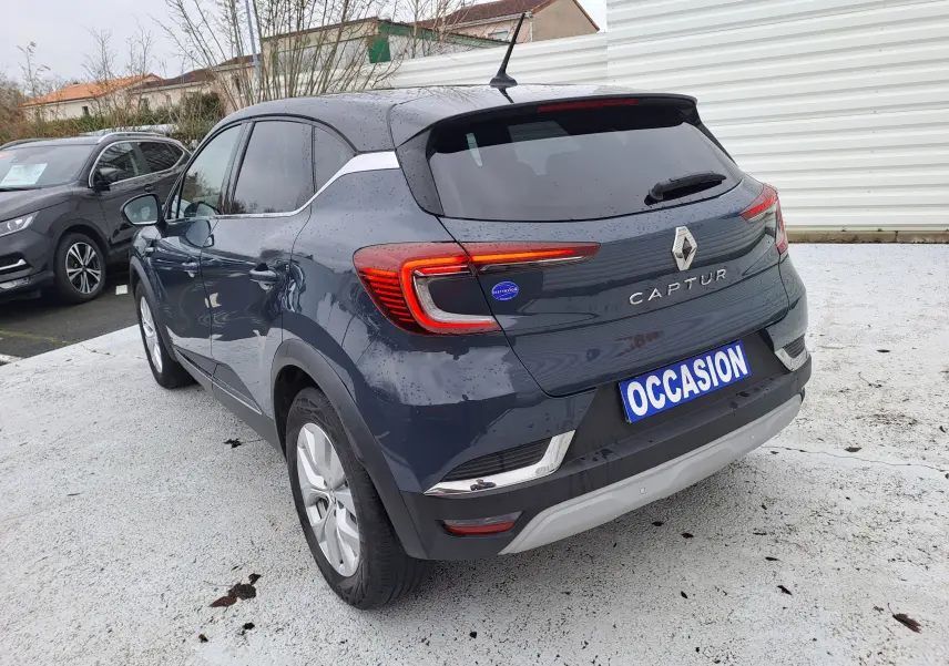 Vue 3/4 arrière d’un Renault Captur bleu marine 2022 avec feux LED et plaque « OCCASION » visible.