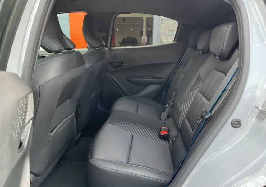 Vue intérieure côté droit sur la banquette arrière en cuir et tissu noir avec surpiqûres bleues de la Renault Clio Gris Rafale 2026.