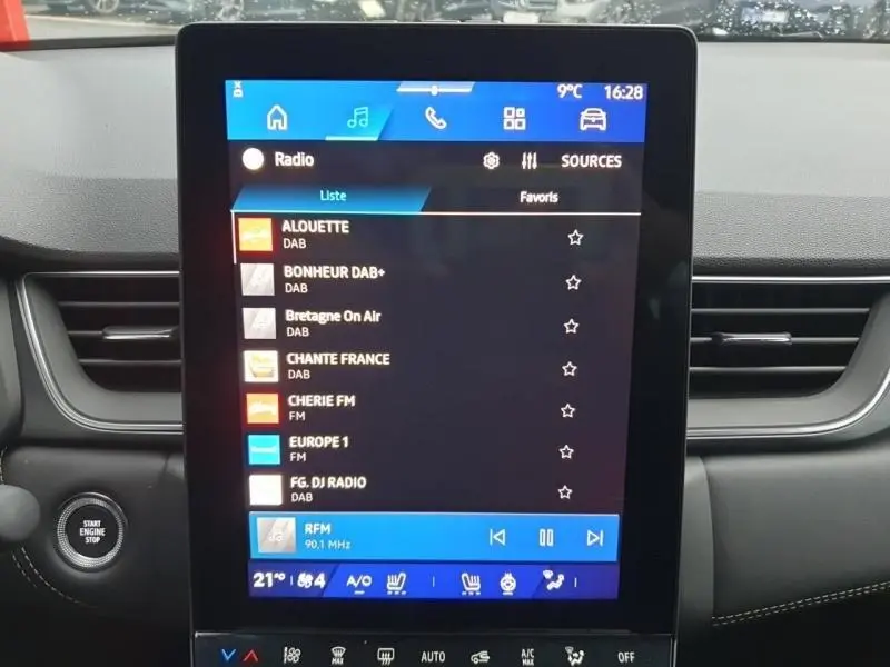 Écran tactile central allumé dans l’habitacle noir d’une Renault Symbioz 2025, affichant les stations radio.