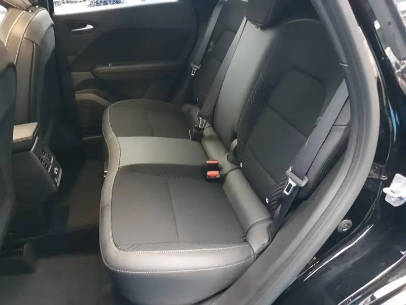 Vue intérieure côté droit sur la banquette arrière noire étoilée du Renault Symbioz 2025 avec ceintures et accoudoir central.