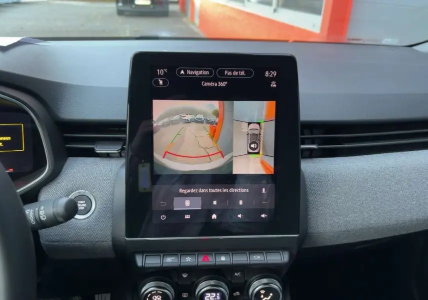 Écran central tactile affichant la caméra 360° dans l'habitacle d'une Renault Clio gris rafale, vue de face.