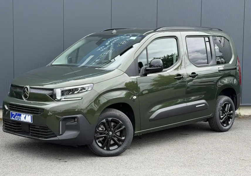 Vue 3/4 avant droite d'un Citroën Berlingo Multispace vert Sirkka avec jantes noires et barres de toit noires.