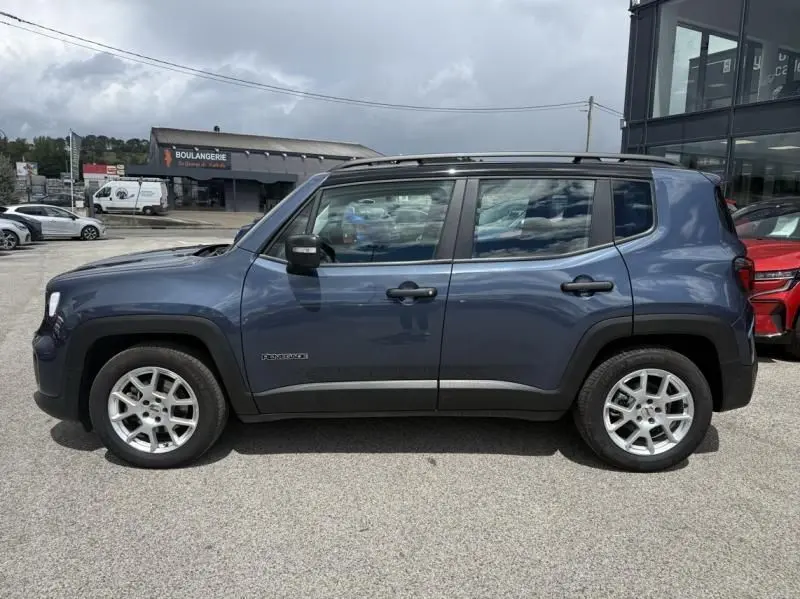 Vue de profil côté gauche d’un Jeep Renegade 2024 bleu métal avec jantes argentées et détails noirs sur les passages de roues.