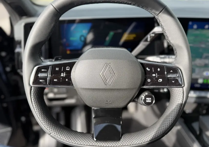 Vue intérieure du tableau de bord du Renault Austral noir étoile 2026, avec écran tactile affichant la navigation GPS en mode satellite.