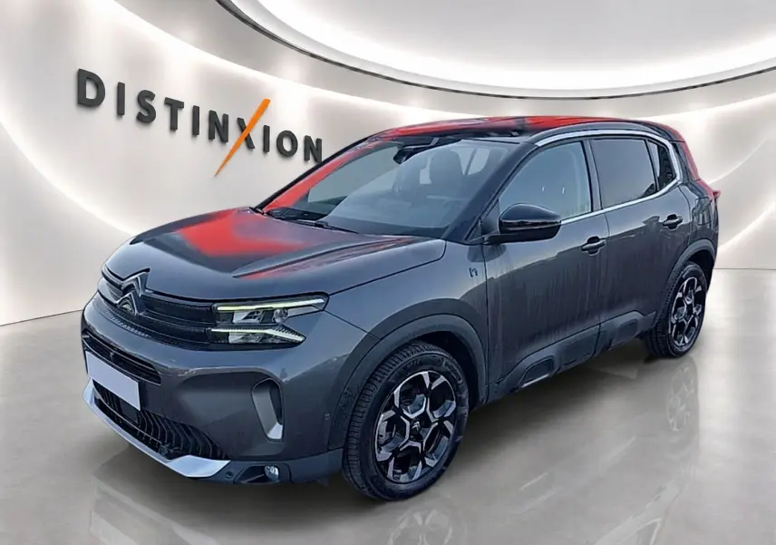 Citroën C5 Aircross hybride gris platinium en 3/4 avant droit, avec jantes noires et toit noir contrasté.
