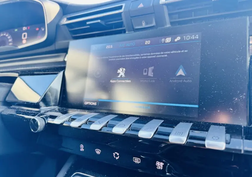Vue rapprochée de la console centrale tactile et des commandes piano chromées du Peugeot 508 gris Amazonite, intérieur noir.