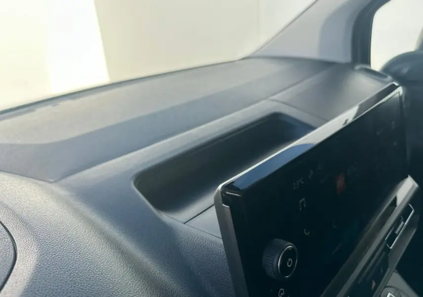 Vue intérieure rapprochée du tableau de bord noir avec écran tactile du Citroën Berlingo blanc Icy 2026.