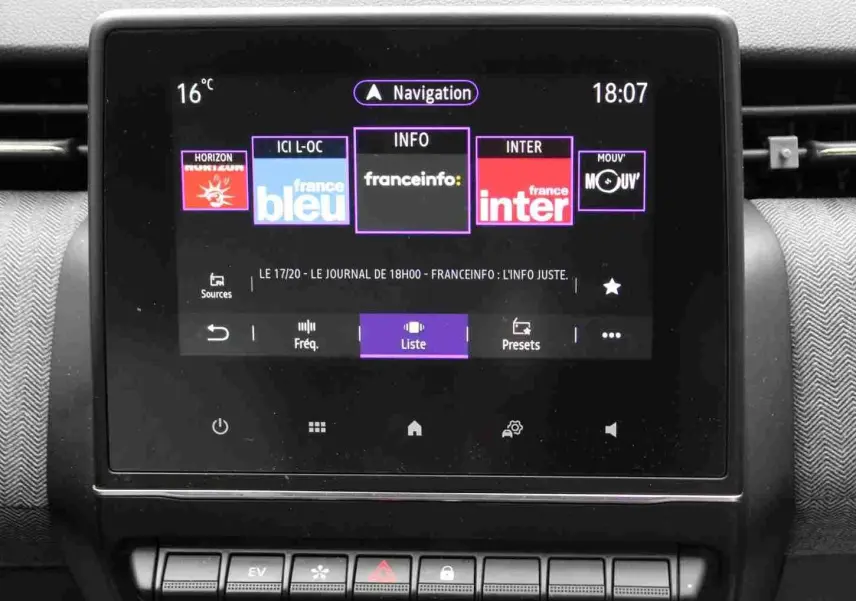 Écran tactile central de la Renault Clio 2025 affichant les stations radio, avec tableau de bord gris noir en arrière-plan.