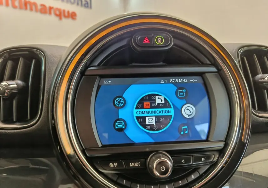Détail du tableau de bord MINI Countryman 2019 noir, écran central rond avec interface multimédia bleue.