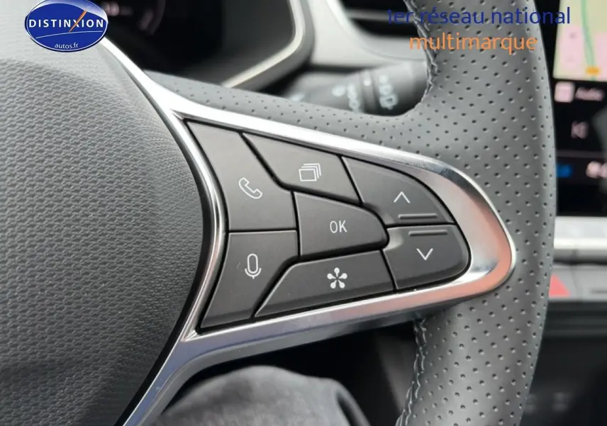 Gros plan sur les commandes multifonctions du volant perforé du Renault Captur 1.8 e-tech hybride 2026.