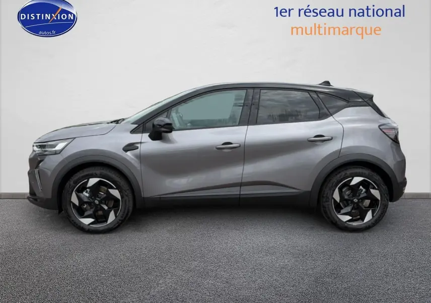 Profil droit du Renault Captur 2026 gris Cassiope avec toit noir et jantes alu noires et argentées.