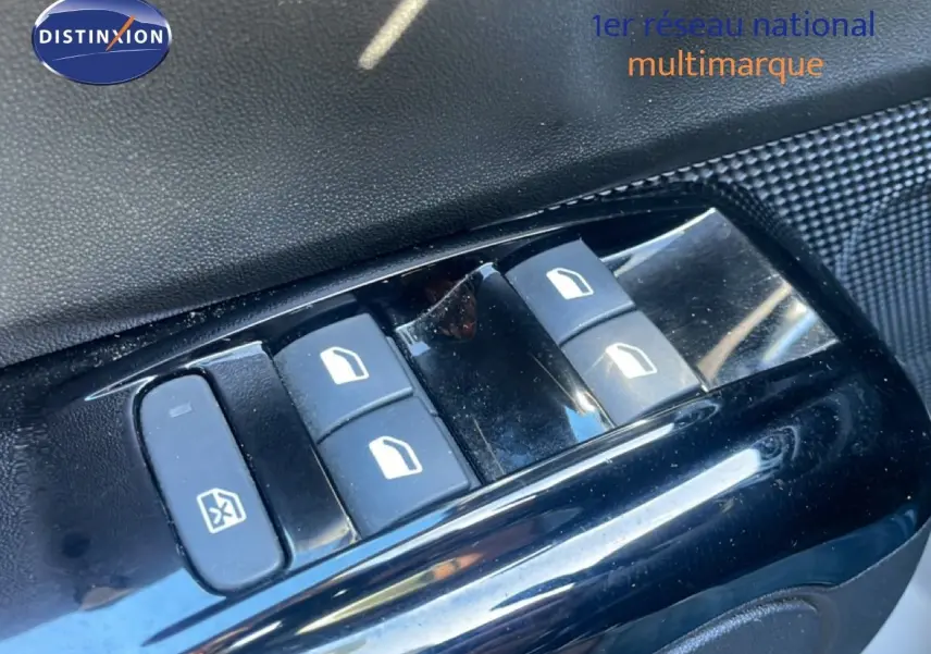 Gros plan sur les commandes de lève-vitres côté conducteur d'une Citroën C3 blanche banquise de 2020.