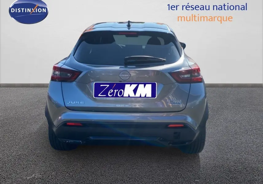 Vue arrière du Nissan Juke 2025 gris squale métal avec toit noir, mettant en valeur ses feux LED et son design compact.