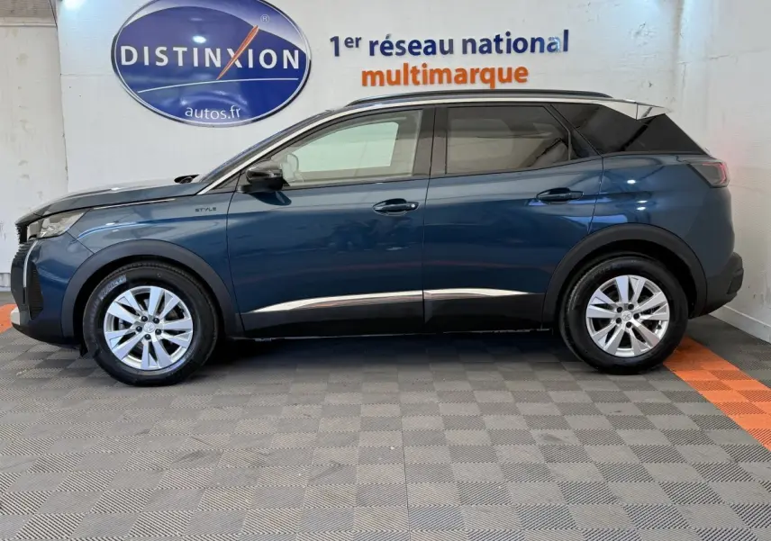 Vue de profil côté gauche d’un Peugeot 3008 bleu 2021 version Style avec toit noir et jantes argentées.