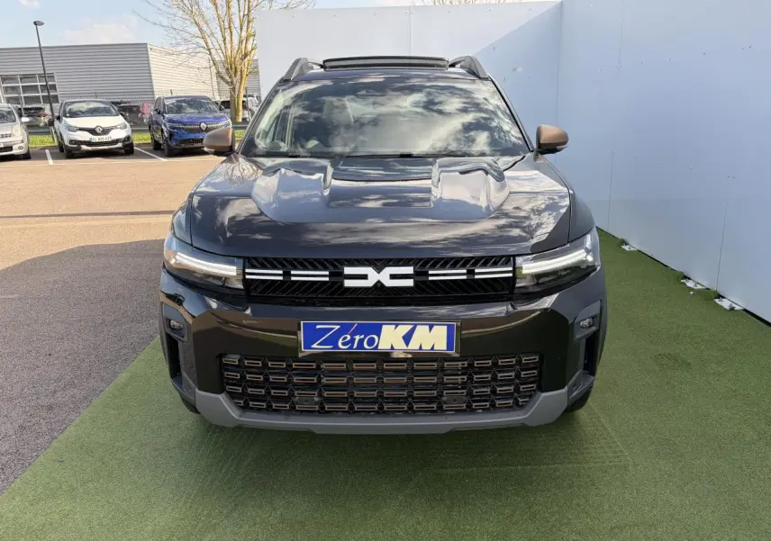 Vue avant du Dacia Bigster noir nacré 2025 avec calandre et détails brun cuivré, toit panoramique ouvrant visible.