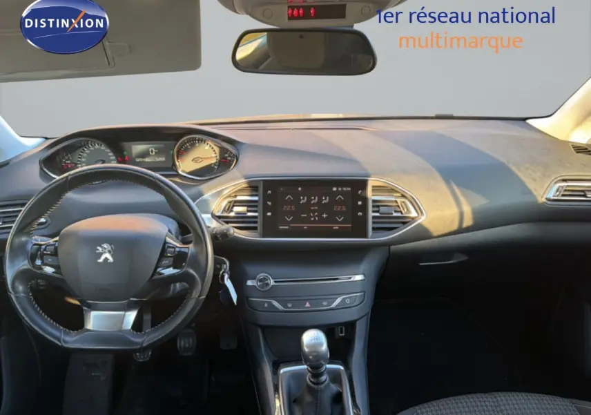 Tableau de bord et volant noir de la Peugeot 308 SW 1.5 BlueHDi 2019 vus de face, avec écran tactile central allumé.