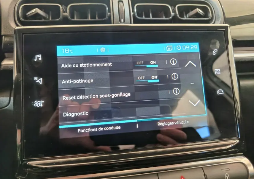 Écran tactile central affichant les réglages d'aide à la conduite dans l'habitacle d'une Citroën C3 blanche.