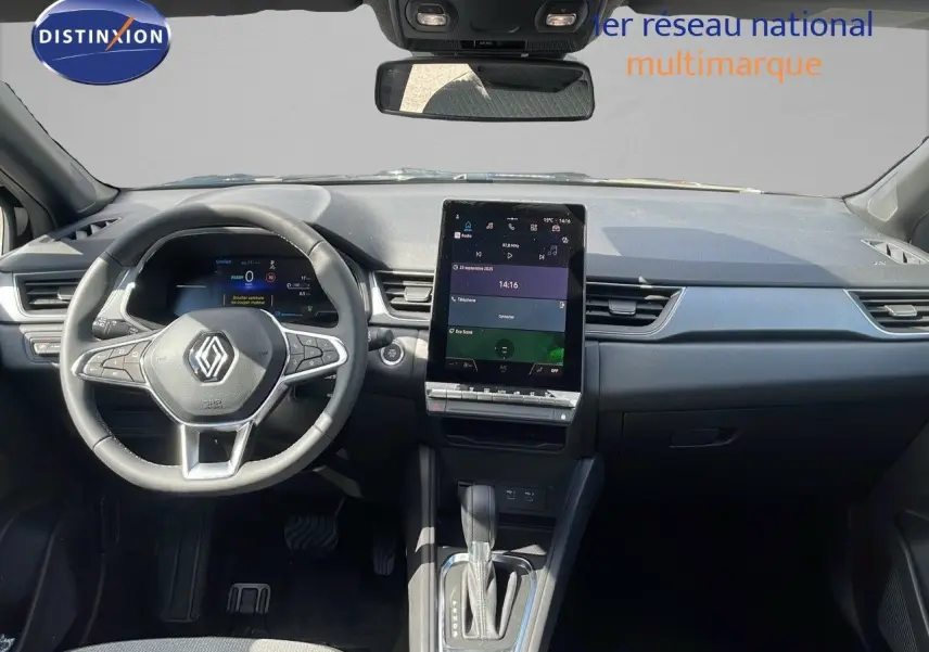 Vue intérieure frontale du tableau de bord du Renault Captur 2025 noir étoile métal avec écran tactile vertical et volant multifonction.