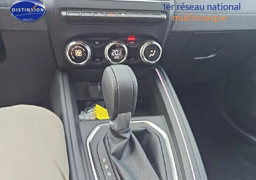 Le levier de boîte manuelle noir et la console centrale avec commandes de climatisation d'une Renault Clio V gris schiste.
