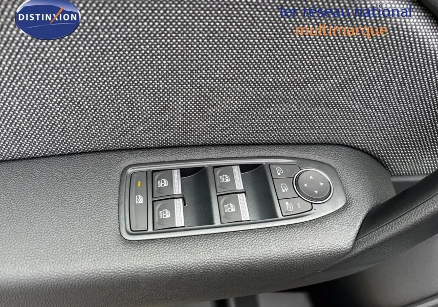 Gros plan sur les commandes de lève-vitres et rétroviseurs côté conducteur d’un Renault Captur gris Rafale 2025.