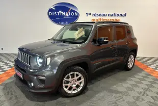 Jeep Renegade gris graphite en 3/4 avant droit, avec toit ouvrant et jantes argentées visibles en intérieur showroom.
