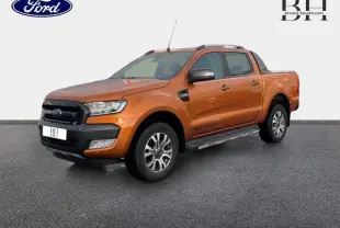 Ford Ranger Wildtrak 2017 Pride Orange métallisée, vue 3/4 avant droit avec barres de toit et marchepieds.