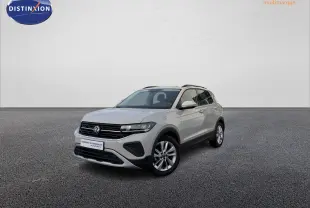Volkswagen T-Cross gris vue 3/4 avant droit sur sol gris, avec jantes alliage et calandre noire distinctive.